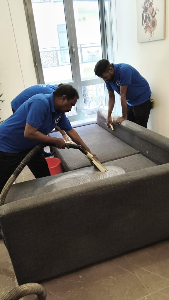 Technicians wet extracting and deep cleaning modern sofa in Kuwait